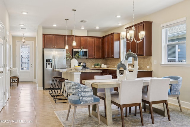 48 Gilchrist Way, Saint Johns, FL 32092 - kitchen with appliances with stainless steel finishes, a kitchen island, backsplash, pendant lighting, and recessed lighting