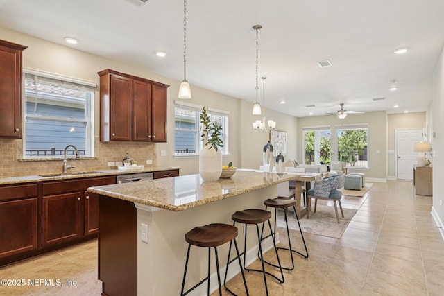 48 Gilchrist Way, Saint Johns, FL 32092 - kitchen with ceiling fan, tasteful backsplash, light stone counters, a center island, and recessed lighting