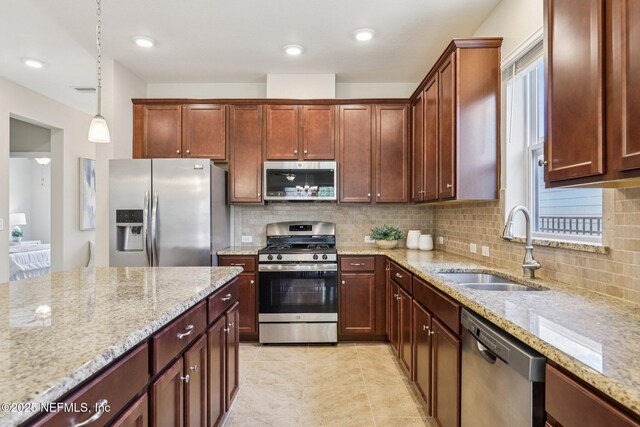 48 Gilchrist Way, Saint Johns, FL 32092 - kitchen featuring appliances with stainless steel finishes, tasteful backsplash, light stone countertops, pendant lighting, and light tile patterned floors