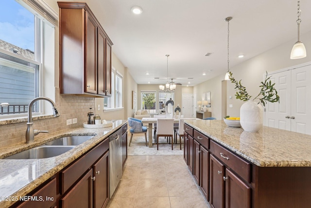 48 Gilchrist Way, Saint Johns, FL 32092 - kitchen with dishwasher, pendant lighting, decorative backsplash, light tile patterned floors, and light stone counters