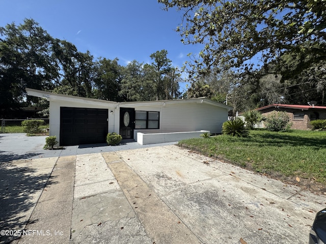 7942 Helston Dr, Jacksonville, FL 32208 - view of front of home featuring driveway, a garage, and a front yard