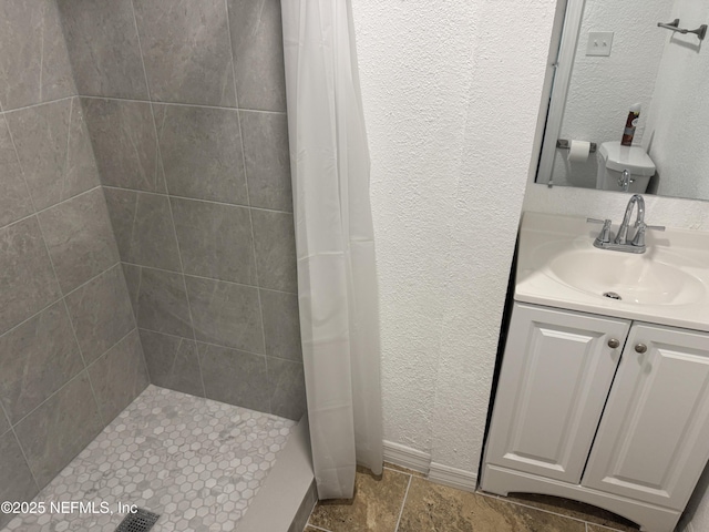 7942 Helston Dr, Jacksonville, FL 32208 - full bath featuring tiled shower, vanity, and a textured wall