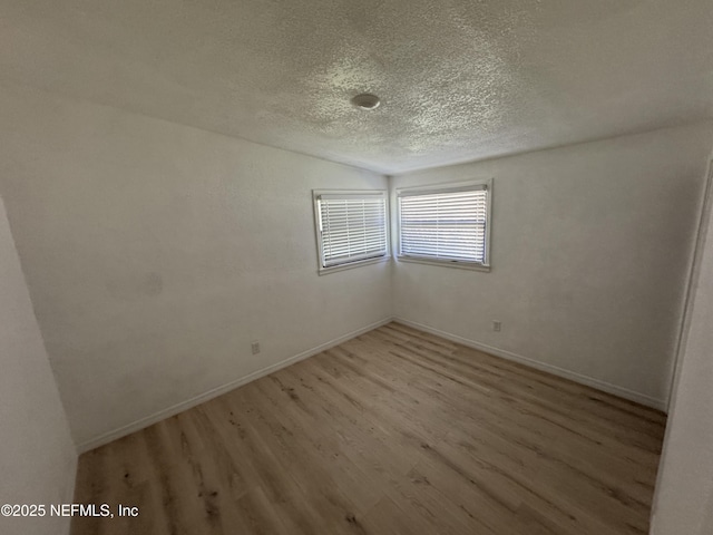 7942 Helston Dr, Jacksonville, FL 32208 - spare room featuring light wood finished floors and a textured ceiling