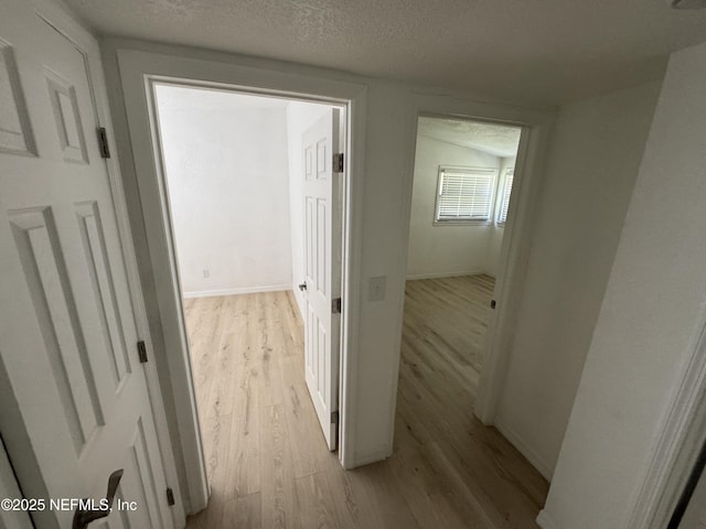 7942 Helston Dr, Jacksonville, FL 32208 - hall with light wood-type flooring and a textured ceiling