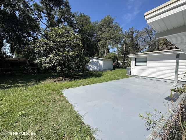 7942 Helston Dr, Jacksonville, FL 32208 - view of grassy yard with a patio