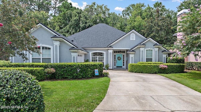 121 Bouganvilla Dr, Ponte Vedra Beach, FL 32082 - view of front of property with stucco siding, a front lawn, and a shingled roof