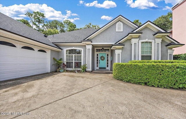 121 Bouganvilla Dr, Ponte Vedra Beach, FL 32082 - view of front of house featuring concrete driveway, stucco siding, a garage, and roof with shingles