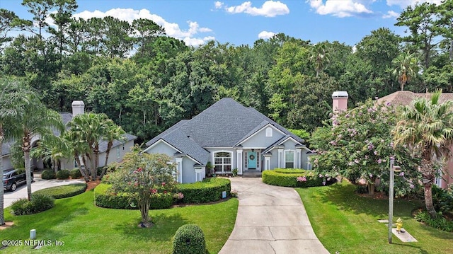121 Bouganvilla Dr, Ponte Vedra Beach, FL 32082 - view of front facade featuring a front yard, driveway, and a shingled roof