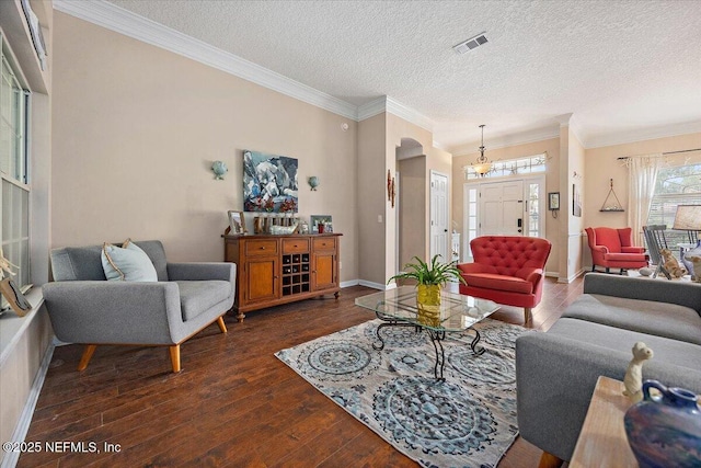 121 Bouganvilla Dr, Ponte Vedra Beach, FL 32082 - living area with dark wood-type flooring, crown molding, arched walkways, and a textured ceiling