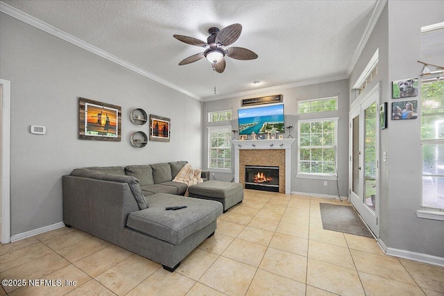 121 Bouganvilla Dr, Ponte Vedra Beach, FL 32082 - living area with ceiling fan, light tile patterned flooring, a fireplace, a textured ceiling, and crown molding