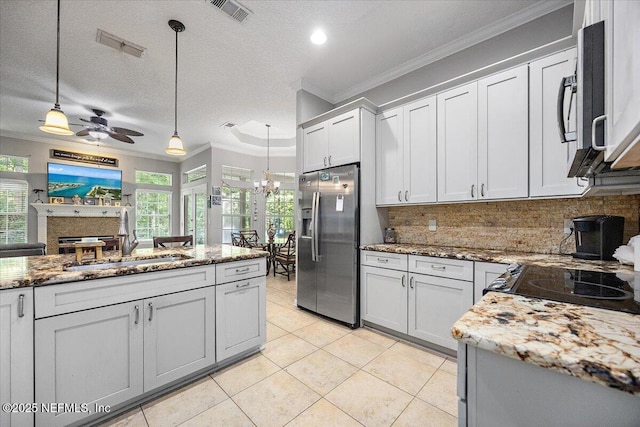 121 Bouganvilla Dr, Ponte Vedra Beach, FL 32082 - kitchen with appliances with stainless steel finishes, crown molding, decorative backsplash, decorative light fixtures, and light stone counters