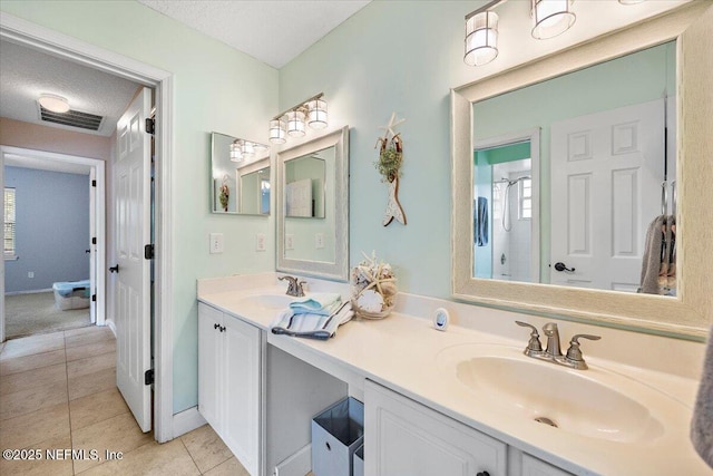 121 Bouganvilla Dr, Ponte Vedra Beach, FL 32082 - bathroom featuring double vanity, tile patterned floors, and a textured ceiling