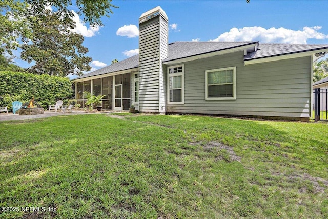 121 Bouganvilla Dr, Ponte Vedra Beach, FL 32082 - rear view of property featuring an outdoor fire pit, a sunroom, a chimney, and roof with shingles
