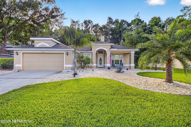 8523 Hampton Landing Dr, Jacksonville, FL 32256 - view of front facade with a front lawn, driveway, and stucco siding