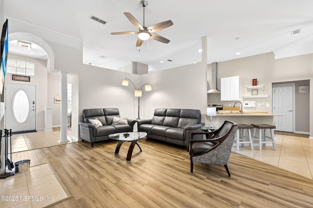8523 Hampton Landing Dr, Jacksonville, FL 32256 - living room with decorative columns, ceiling fan, a high ceiling, light wood-style flooring, and recessed lighting
