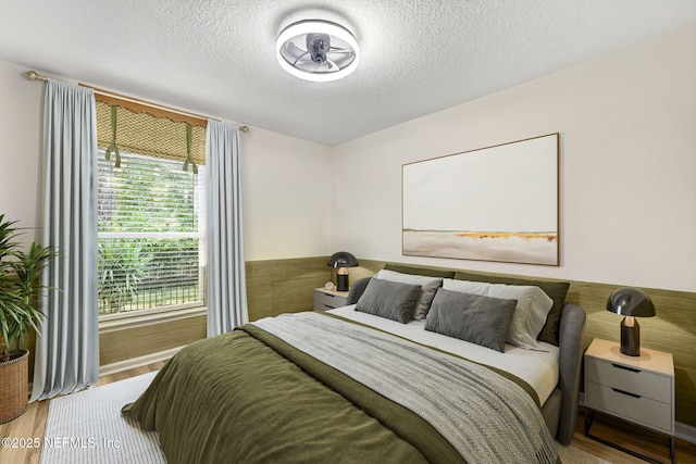 8523 Hampton Landing Dr, Jacksonville, FL 32256 - bedroom with wood finished floors and a textured ceiling