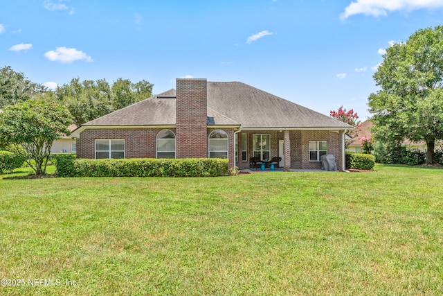 13707 Alesbury Ct, Jacksonville, FL 32224 - back of house featuring a yard, a chimney, brick siding, and roof with shingles