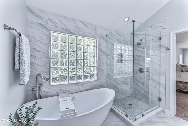 13707 Alesbury Ct, Jacksonville, FL 32224 - bathroom featuring a soaking tub, a shower stall, marble look tiles, ensuite bathroom, and tile walls