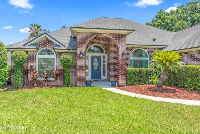13707 Alesbury Ct, Jacksonville, FL 32224 - view of front of home featuring brick siding, a shingled roof, and a front lawn