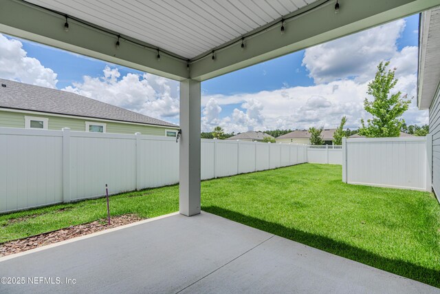 575 Buttonwood Loop, Yulee, FL 32097 - fenced backyard with a patio area