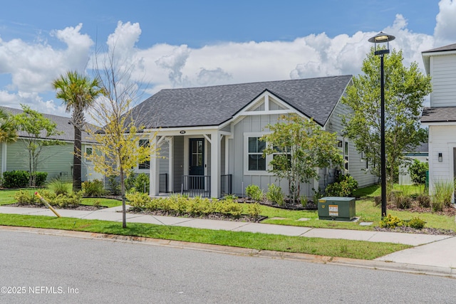 575 Buttonwood Loop, Yulee, FL 32097 - view of front facade with board and batten siding, roof with shingles, and a porch