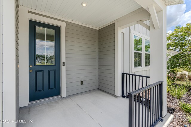 575 Buttonwood Loop, Yulee, FL 32097 - view of exterior entry featuring board and batten siding