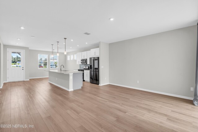 575 Buttonwood Loop, Yulee, FL 32097 - unfurnished living room featuring recessed lighting and light wood-style floors