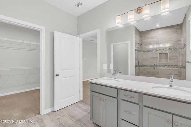 575 Buttonwood Loop, Yulee, FL 32097 - bathroom featuring a shower stall, double vanity, and a spacious closet