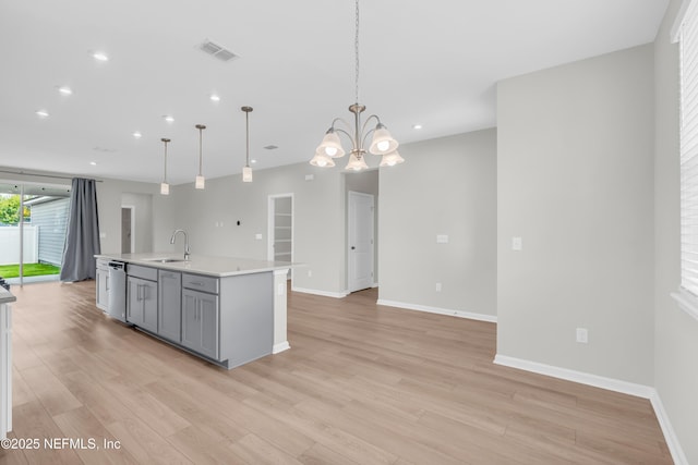 575 Buttonwood Loop, Yulee, FL 32097 - kitchen with gray cabinets, light wood-type flooring, light countertops, recessed lighting, and an island with sink