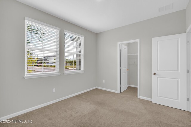575 Buttonwood Loop, Yulee, FL 32097 - unfurnished bedroom featuring carpet flooring and a spacious closet