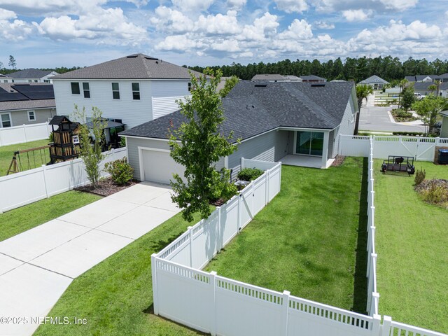 575 Buttonwood Loop, Yulee, FL 32097 - view of front of home featuring roof with shingles, a residential view, an attached garage, concrete driveway, and a fenced backyard