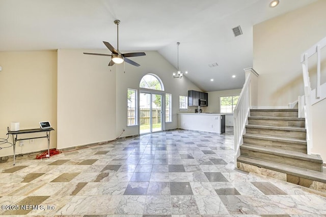 7728 Lynchburg Ct W, Jacksonville, FL 32277 - unfurnished living room featuring a ceiling fan, plenty of natural light, stairway, high vaulted ceiling, and recessed lighting