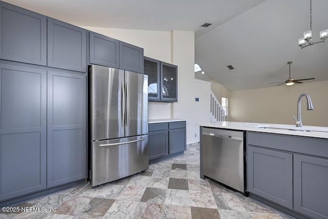 7728 Lynchburg Ct W, Jacksonville, FL 32277 - kitchen with stainless steel appliances, vaulted ceiling, a ceiling fan, gray cabinets, and light countertops