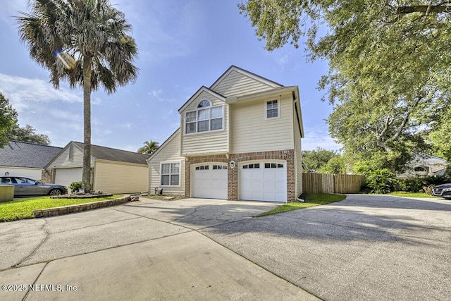 7728 Lynchburg Ct W, Jacksonville, FL 32277 - view of front of home featuring driveway, brick siding, and an attached garage