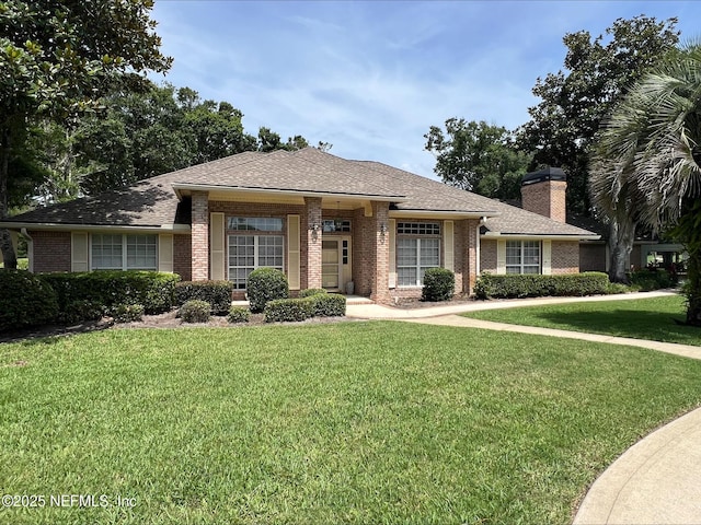 9570 Preston Trl W, Ponte Vedra Beach, FL 32082 - view of front facade featuring brick siding, a front yard, a chimney, and roof with shingles