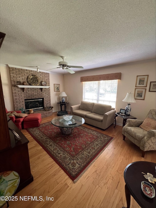 9570 Preston Trl W, Ponte Vedra Beach, FL 32082 - living area featuring a textured ceiling, light wood-style flooring, a fireplace, and ceiling fan