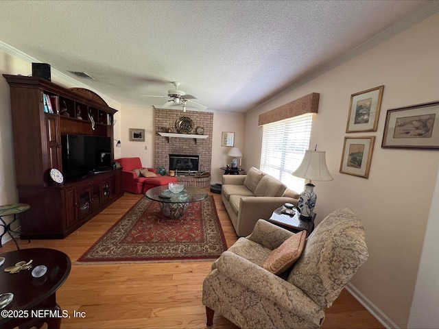 9570 Preston Trl W, Ponte Vedra Beach, FL 32082 - living area with a ceiling fan, a textured ceiling, light wood-type flooring, crown molding, and a fireplace