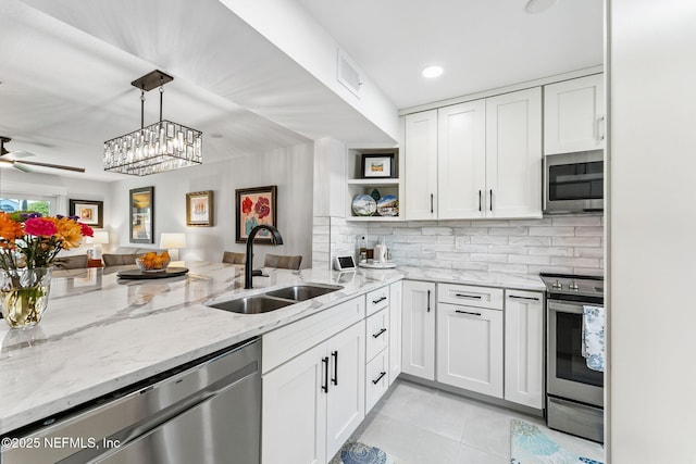 212 16th St Unit A, Saint Augustine Beach, FL 32080 - kitchen featuring appliances with stainless steel finishes, open floor plan, white cabinetry, light tile patterned floors, and open shelves