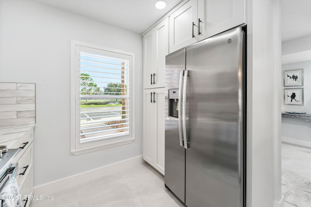212 16th St Unit A, Saint Augustine Beach, FL 32080 - kitchen with stainless steel refrigerator with ice dispenser, white cabinetry, light countertops, and light tile patterned floors