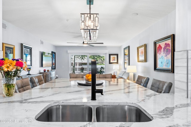 212 16th St Unit A, Saint Augustine Beach, FL 32080 - kitchen featuring open floor plan, a chandelier, light stone counters, decorative light fixtures, and ceiling fan