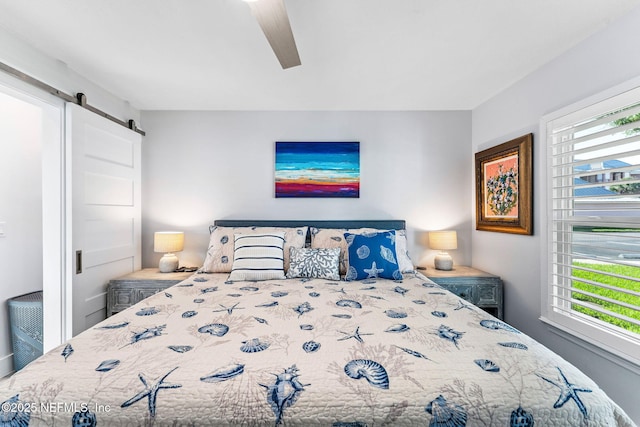 212 16th St Unit A, Saint Augustine Beach, FL 32080 - bedroom with a barn door and ceiling fan