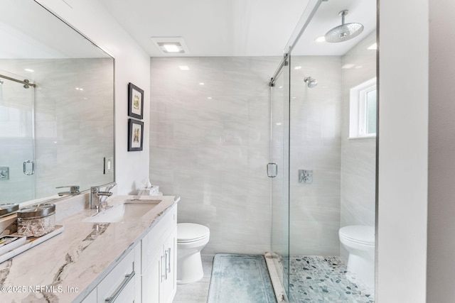 212 16th St Unit A, Saint Augustine Beach, FL 32080 - bathroom featuring vanity, a shower stall, tile patterned floors, and tile walls