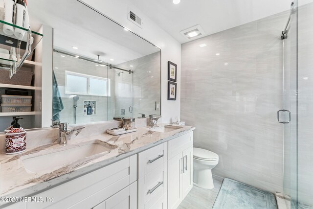 212 16th St Unit A, Saint Augustine Beach, FL 32080 - full bath with double vanity, a shower stall, and tile walls