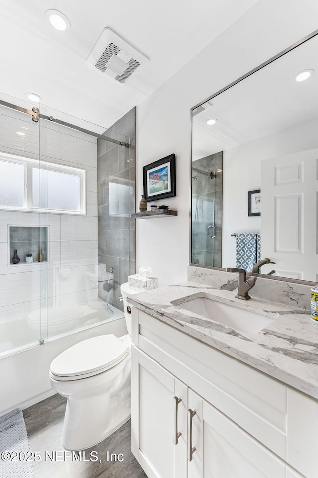 212 16th St Unit A, Saint Augustine Beach, FL 32080 - full bath with vanity, bath / shower combo with glass door, wood finished floors, and recessed lighting