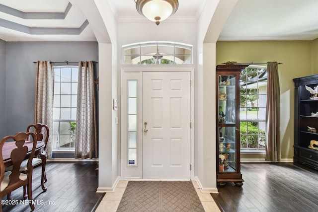 12569 Kernan Forest Blvd, Jacksonville, FL 32225 - entryway featuring plenty of natural light, arched walkways, hardwood / wood-style flooring, and crown molding