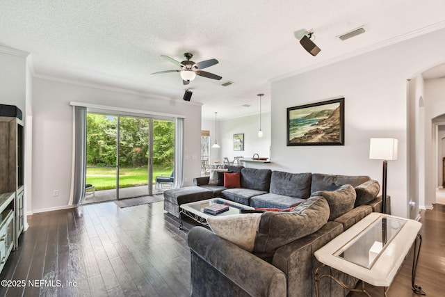 12569 Kernan Forest Blvd, Jacksonville, FL 32225 - living area featuring a ceiling fan, dark wood-type flooring, arched walkways, and ornamental molding