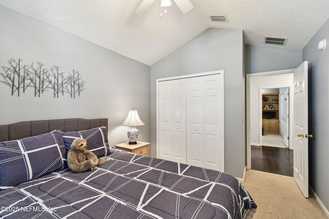 12569 Kernan Forest Blvd, Jacksonville, FL 32225 - carpeted bedroom featuring lofted ceiling, a closet, a ceiling fan, and a textured ceiling