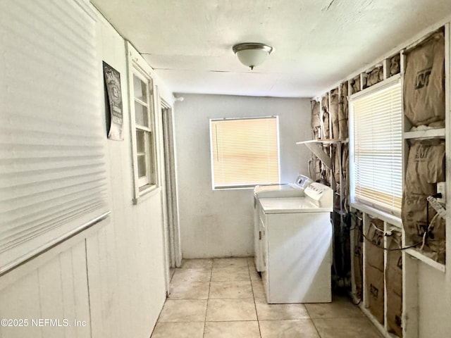8953 Adams Ave, Jacksonville, FL 32208 - laundry area with washer and clothes dryer and light tile patterned flooring