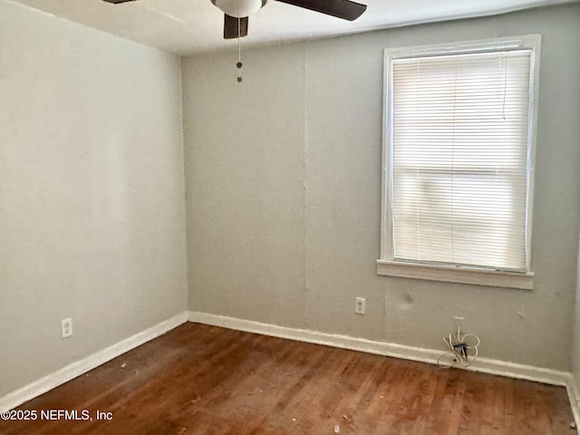 8953 Adams Ave, Jacksonville, FL 32208 - empty room with a ceiling fan and dark wood-type flooring