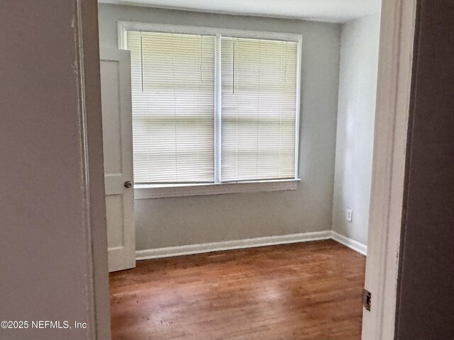 8953 Adams Ave, Jacksonville, FL 32208 - spare room featuring wood finished floors and baseboards